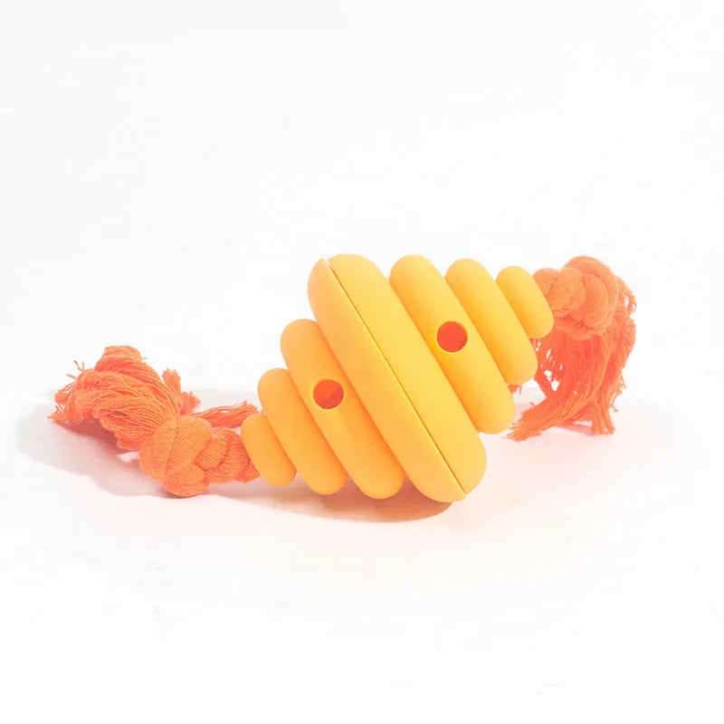 Green and yellow silicone dog ball with attached rope for tug-of-war and treat dispensing