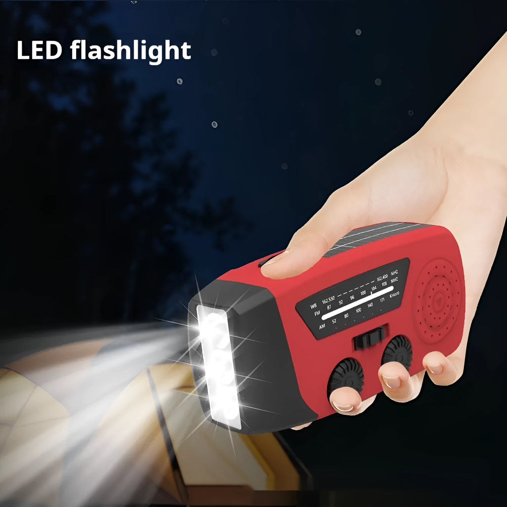 Red rechargeable emergency hand radio with built-in torch showing compact dimensions and wrist strap