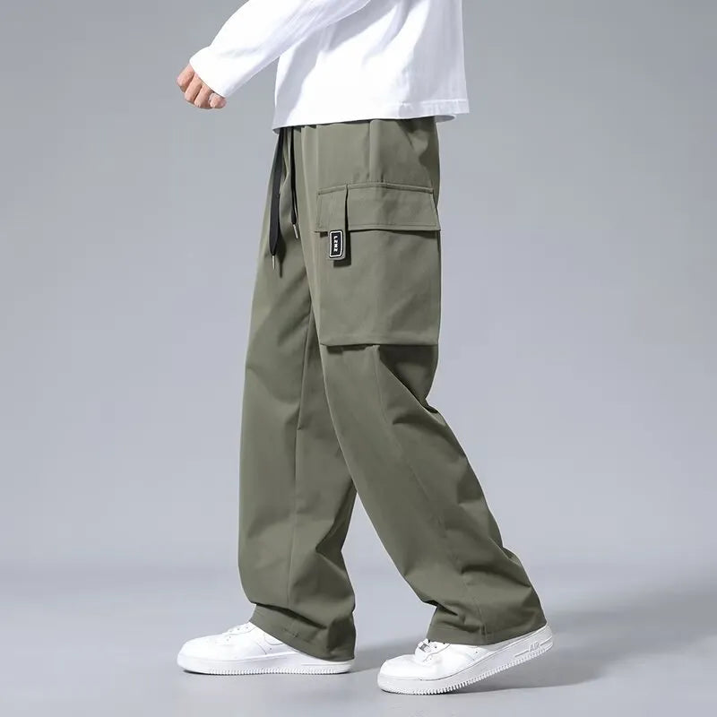 Boys in army green straight leg cargo pants with large pockets and a drawstring waist.