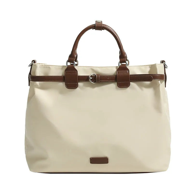 Women's nylon shoulder tote bag in a horizontal square shape showing internal organiser pockets.