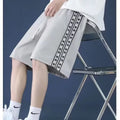 Men's black baggy track pants with loose fit and elasticated waistband for casual sports wear