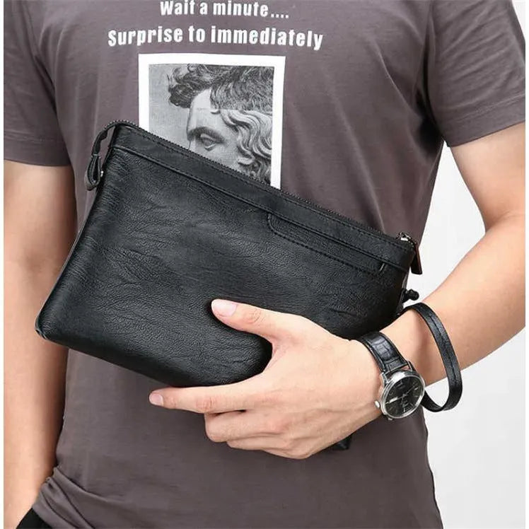 Men's PU leather clutch bag in black with wrist strap, soft carry handle, and zipper compartments