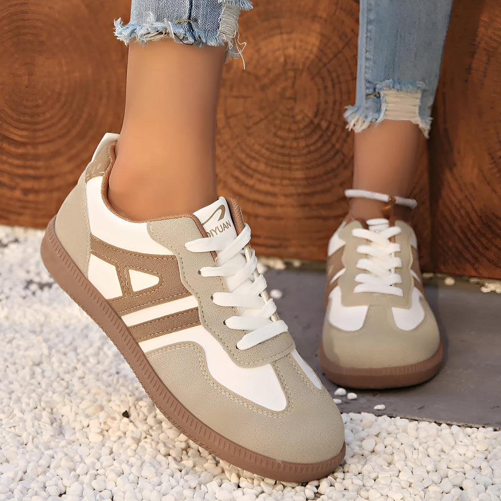 Women's retro colour matching lace-up jogging shoes in grey, showing cross-strap detail and platform sole.