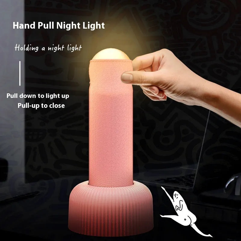 Creative handheld night light with fabric covering on base, emitting warm light
