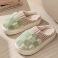 Women's plaid patterned plush slippers with a non-slip PVC sole, shown in a selection of colours including coffee, green, and pink.