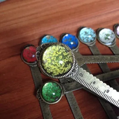 Handmade dried flower ruler bookmark with gypsophila, daffodil, lace flower, and clover on 12cm base in multiple colours.