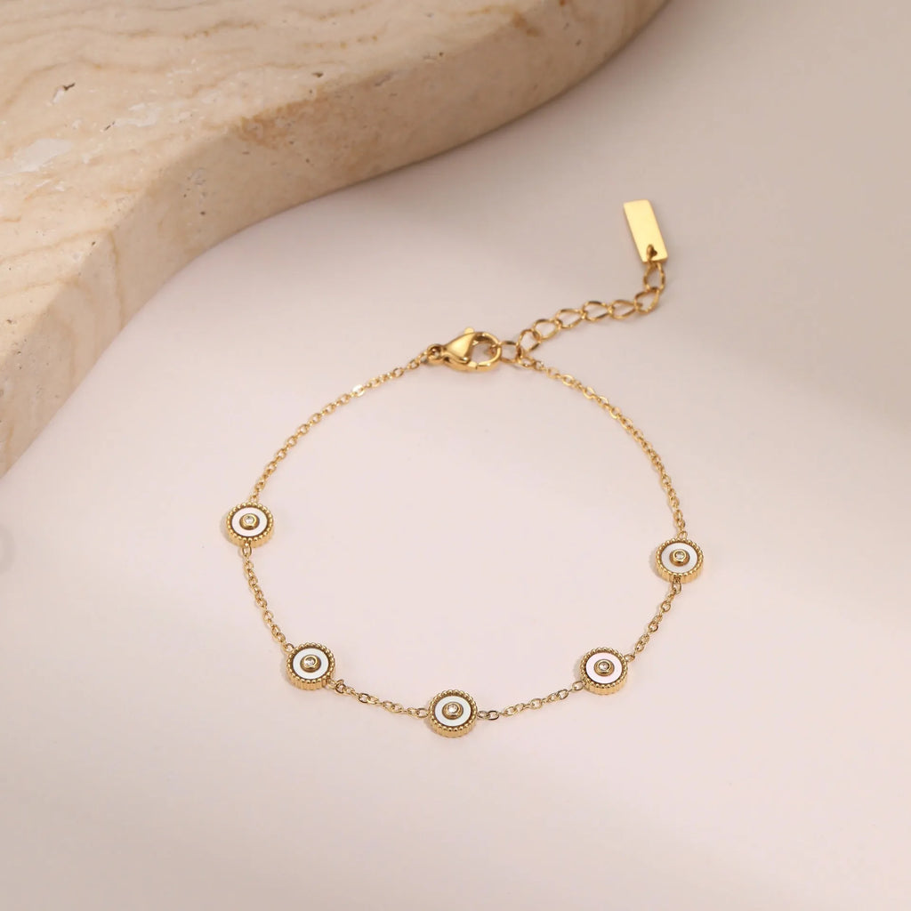 Stainless steel bracelet with 18K gold electroplating and geometric fritillary design, shown with matching necklace