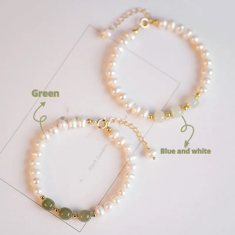 Natural freshwater pearl bracelet with diamond-shaped beads in Hetian jade colour on a wrist.
