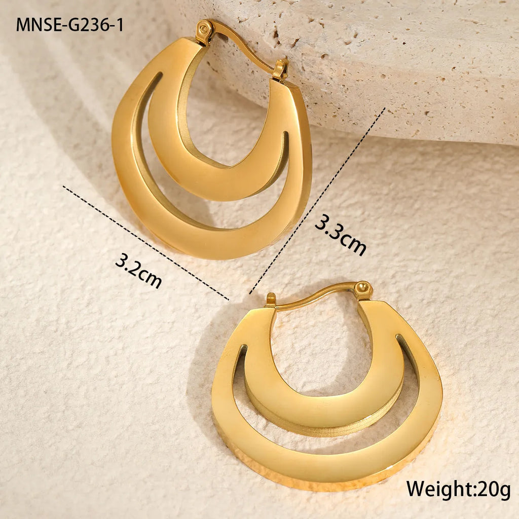 Geometric metallic French earrings with round ring elements in gold and steel finishes