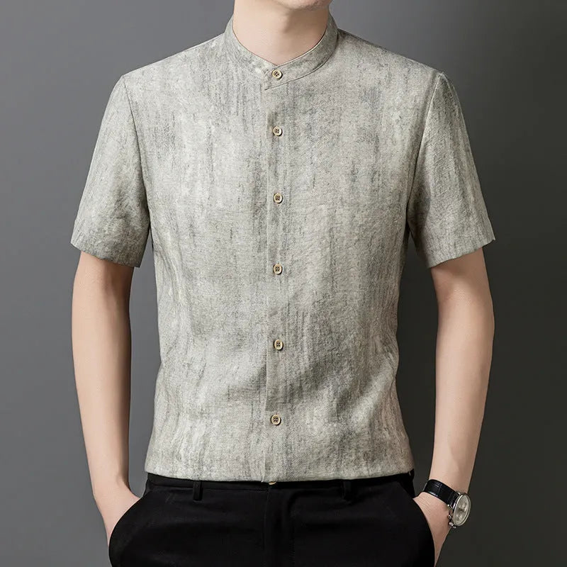 Man wearing a loose-fit black grey linen blend cardigan shirt with a stand collar.