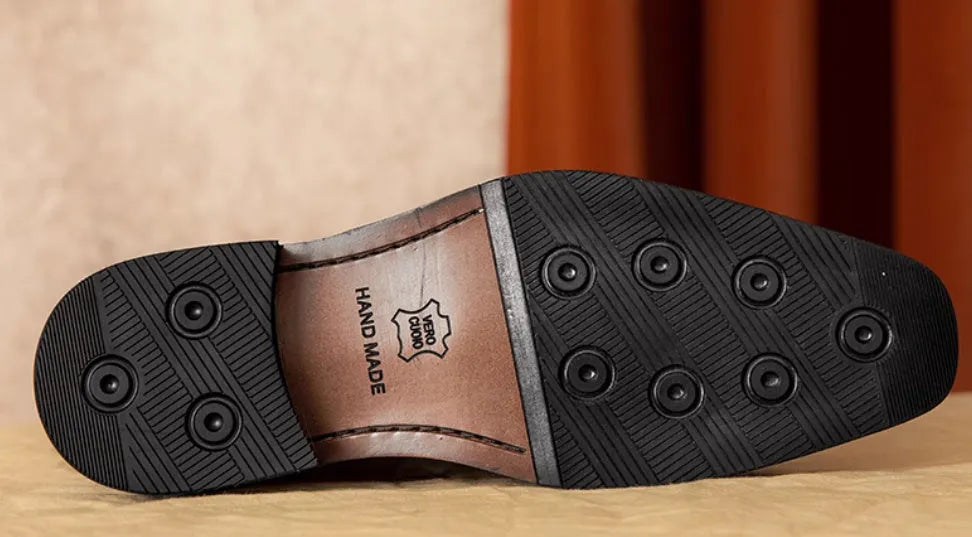 Men's black genuine leather slip-on loafers with fringe detail and rubber sole.