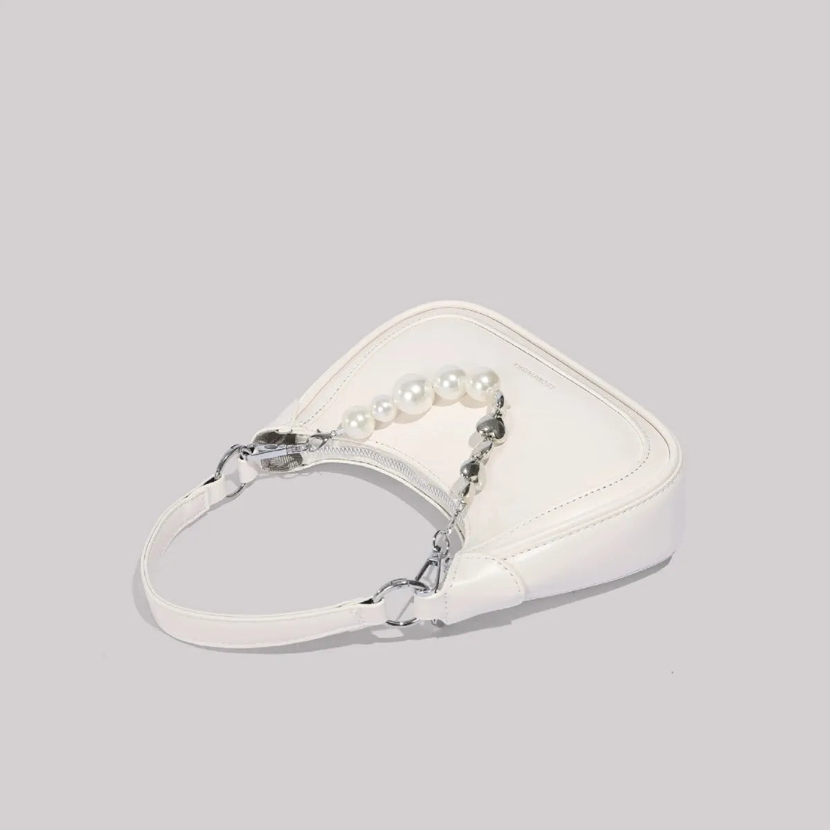 White PU crossbody shoulder bag with vertical square shape, three-dimensional outer pocket, and phone compartment.