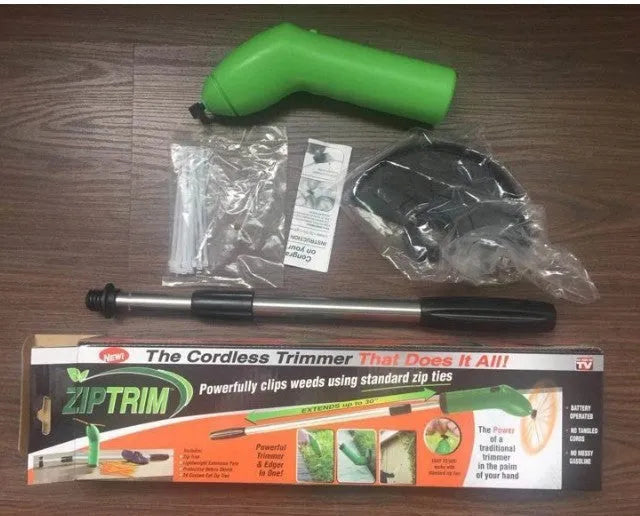 Cordless Zip Trim lawn trimmer with extension pole and protective shield on a garden lawn