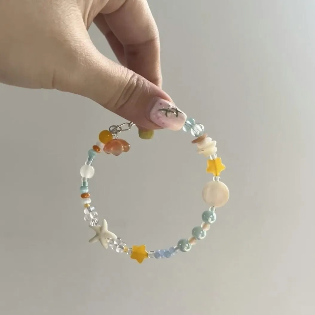 Orange alloy bracelet with diamond shape design and mixed materials for summer seaside wear