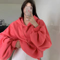 Watermelon red women's mulberry silk hooded sweater with sleeveless design on hanger