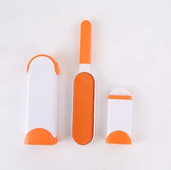 Blue reusable pet hair removal brush with self-cleaning base on a grey sofa.