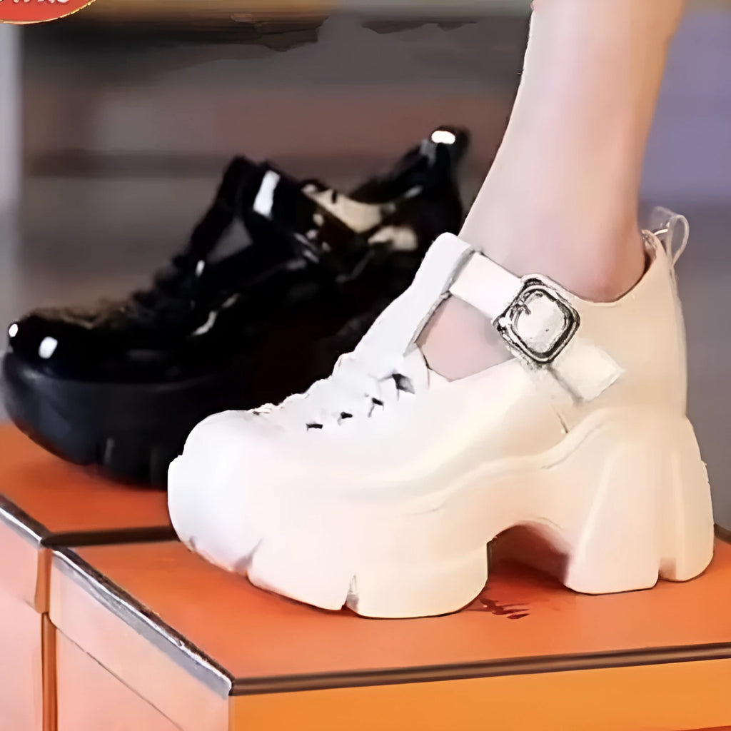 Women's black satin Roman-style pumps with a chunky wedge heel, closed toe, and hollow-out decorative detail.