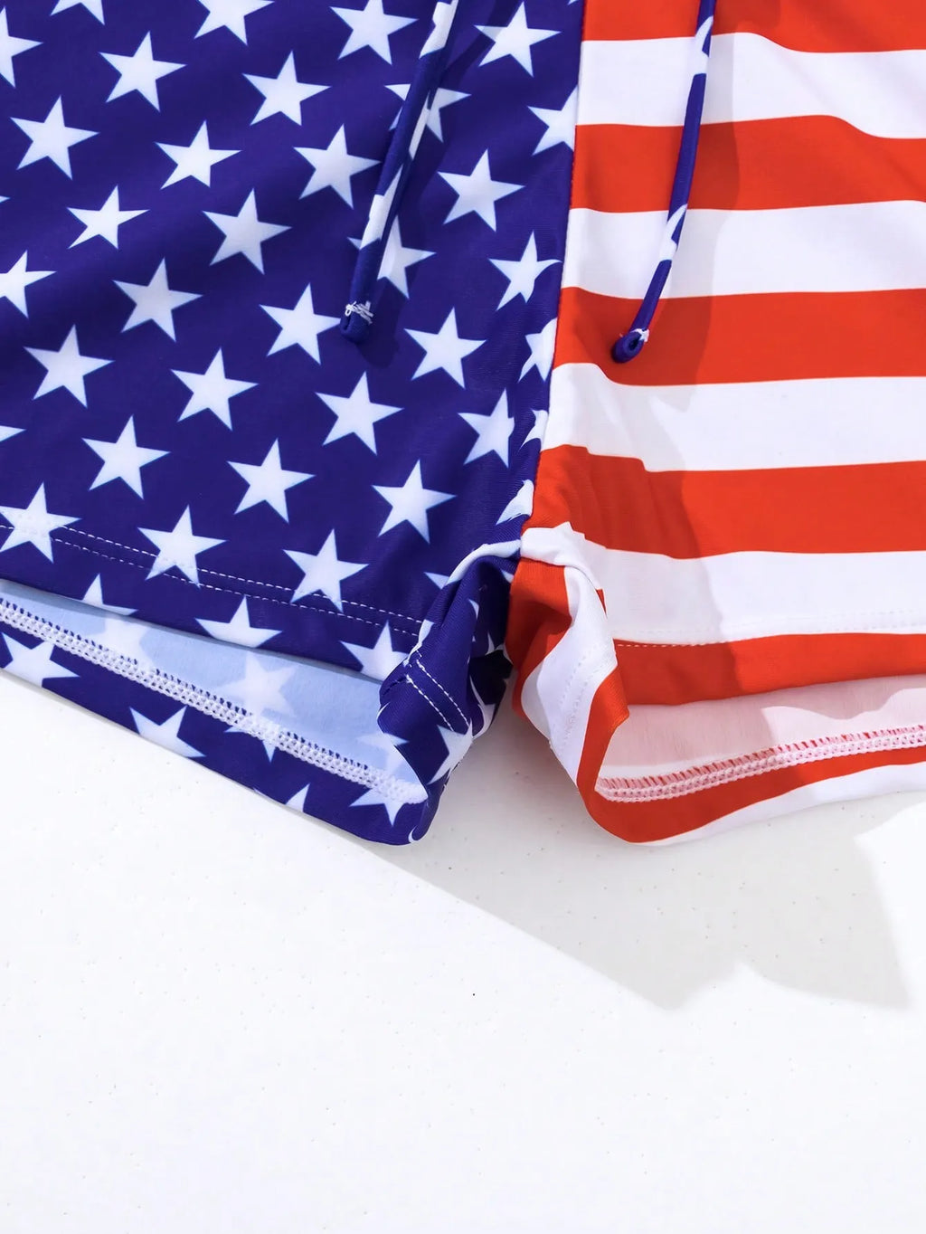 Women's blue and red stars and stripes high-waist swimsuit with a white drawstring waistband