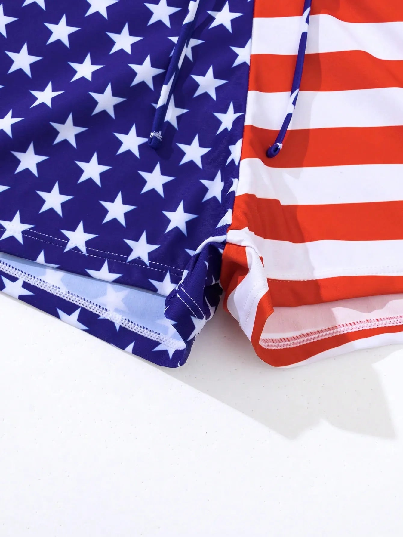 Women's blue and red stars and stripes high-waist swimsuit with a white drawstring waistband
