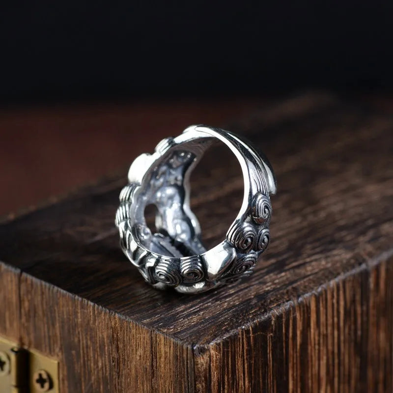 Sterling silver open ring with a detailed domineering jibeast animal and zodiac pattern.
