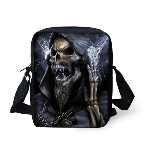 A medium-sized black children's messenger bag with a white skull print, showing a front zipper pocket and a soft top handle.