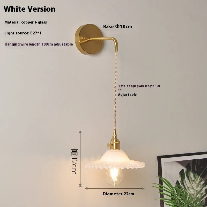 Retro brass bedside lotus wall lamp with transparent glass shade and copper body
