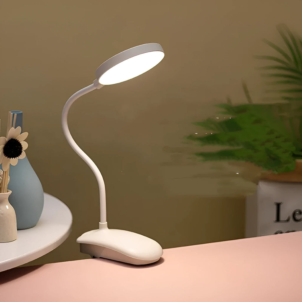 LED clip-on desk lamp with touch dimming, plastic shade, available in white, pink, or green.