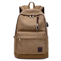 Canvas backpack with USB charging port shown in grey, featuring a laptop sleeve and front zipper pocket.
