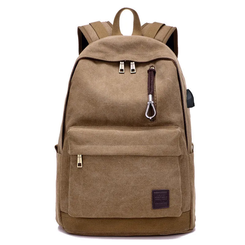 Canvas backpack with USB charging port shown in grey, featuring a laptop sleeve and front zipper pocket.