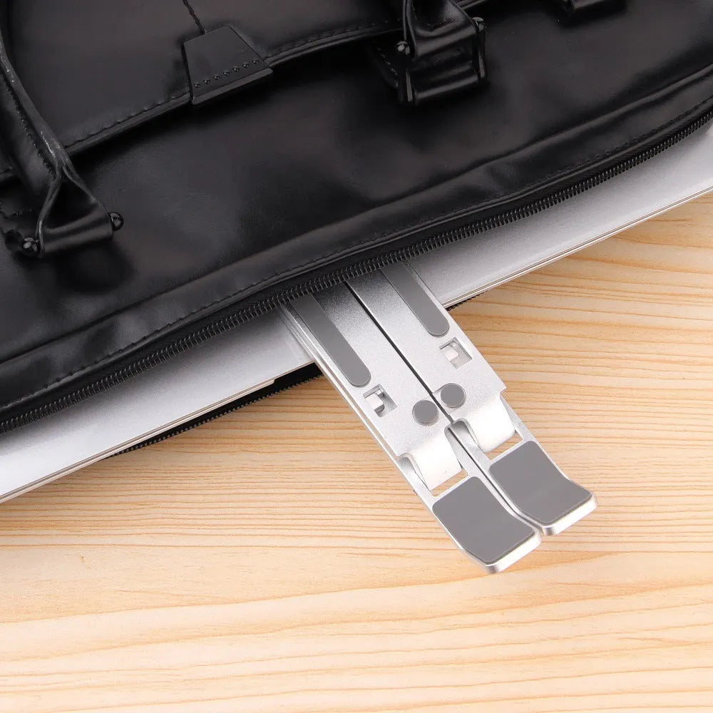 Silver folding laptop stand made from aluminium alloy and silicone for laptops, books and tablets under 16 inches