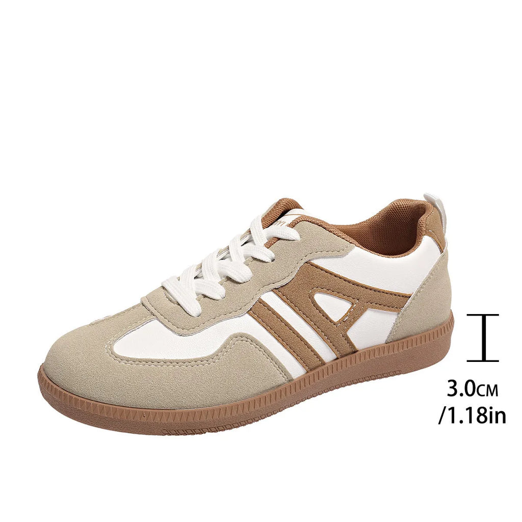 Women's retro colour matching lace-up jogging shoes in grey, showing cross-strap detail and platform sole.