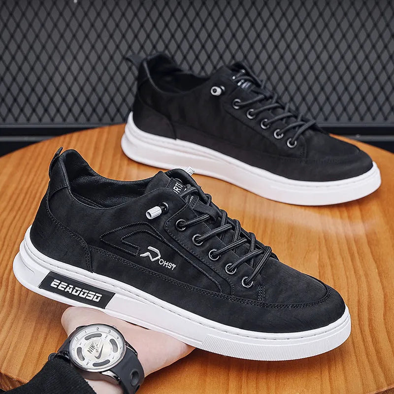 Grey men's canvas lace-up sneakers with round toe and low-top design on a rubber sole.