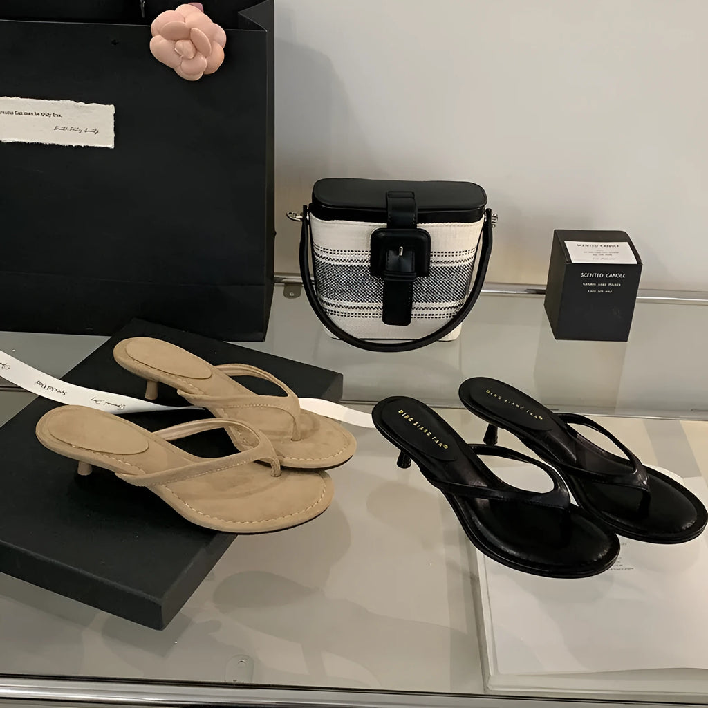 Women's black rubber stiletto sandals with round toe and open-toed design on a white background.