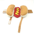 Brown and beige hot dog costume on a small dog, showing plush bun, sausage, and fabric mustard and ketchup toppings.