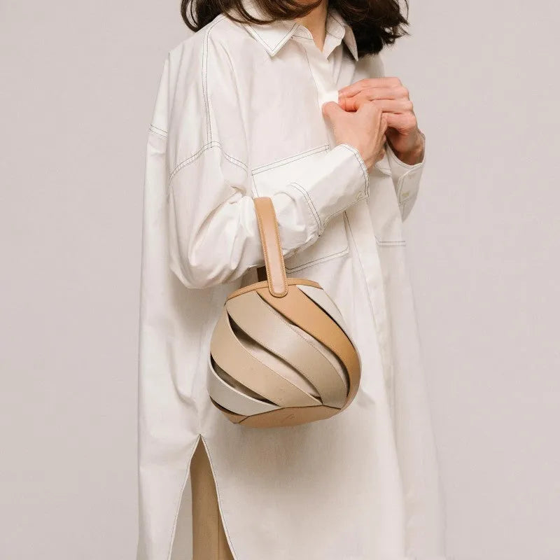 Cylindrical diamond quilted bucket bag in beige with contrast stitching