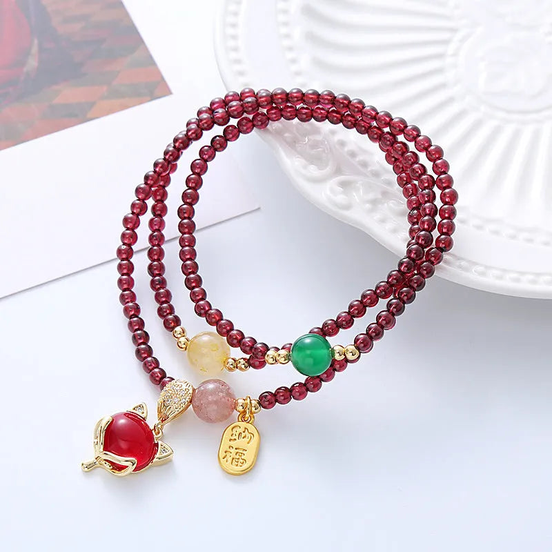 Purplish red garnet crystal bracelet with fox charm and adjustable rope