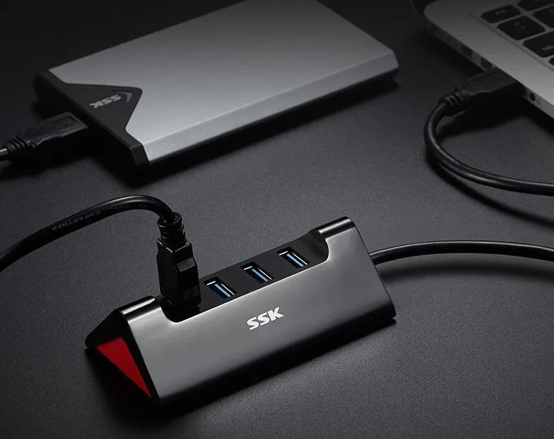Black USB expansion hub with four ports and a Micro USB power connector.