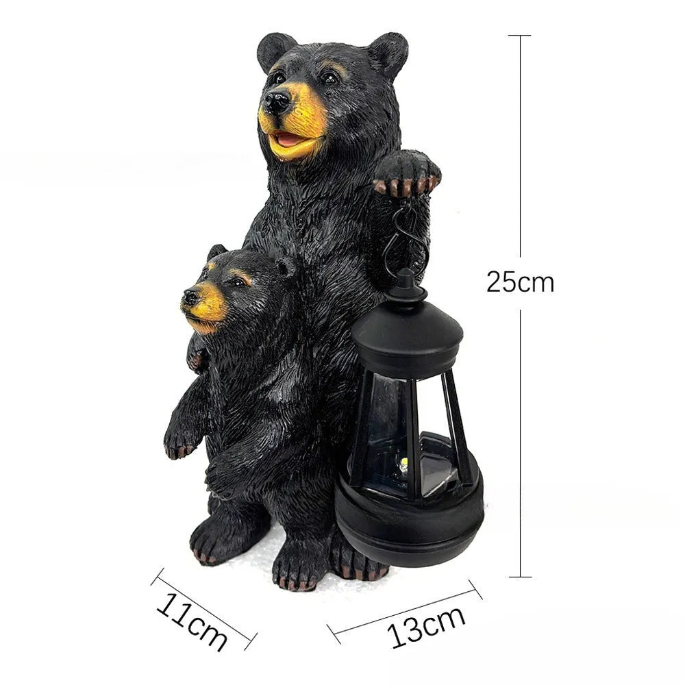 Resin black bear mother and child lantern ornament on a wooden shelf with soft glow