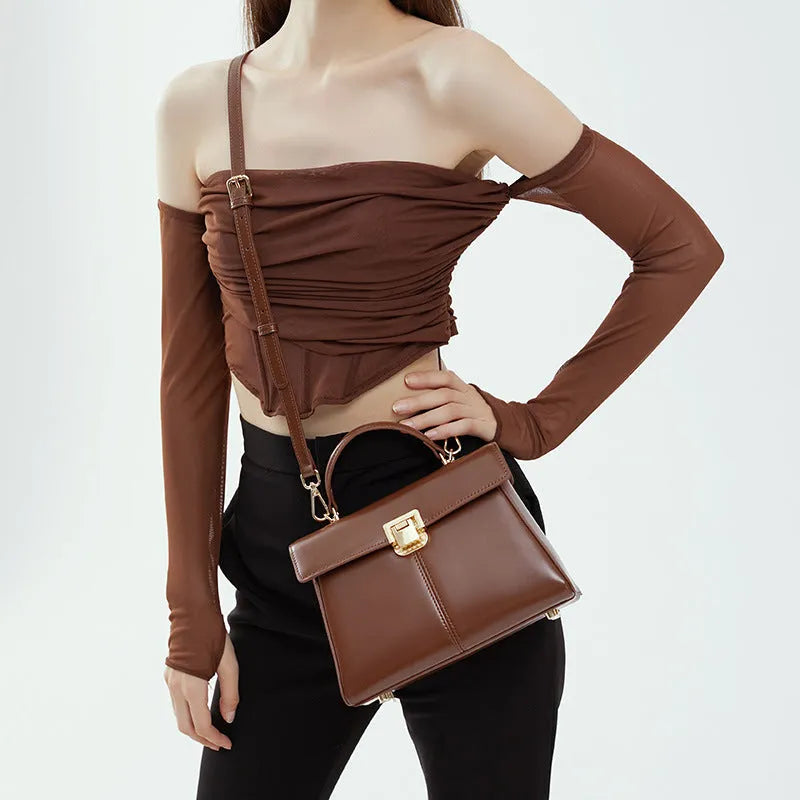 Genuine leather women's shoulder bag with clasp closure showing interior hidden compartment