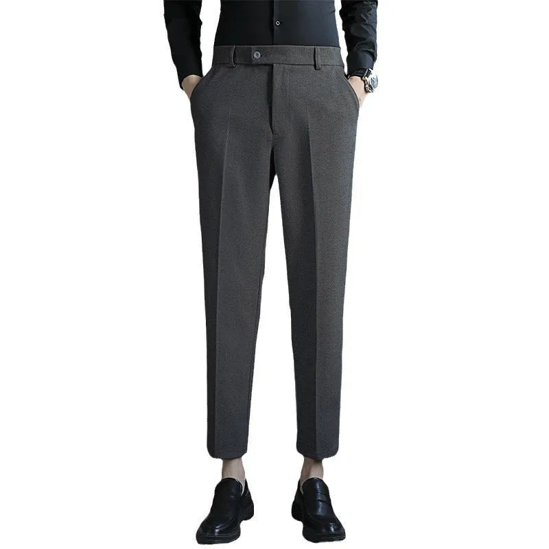 Brown straight leg corduroy trousers for men laid flat, showing slim fit and elastic waistband detail.