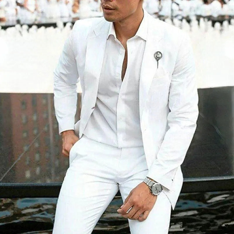 White men's slim fit two-piece suit jacket and trousers on a hanger.