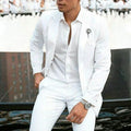 White men's slim fit two-piece suit jacket and trousers on a hanger.