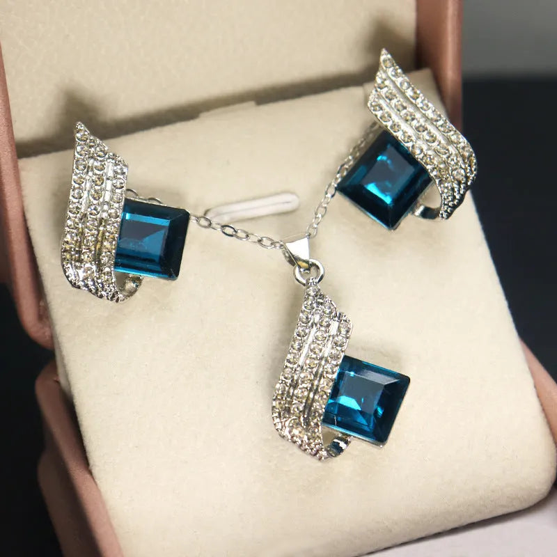 Women's alloy and glass necklace with matching ear studs featuring cross chain design