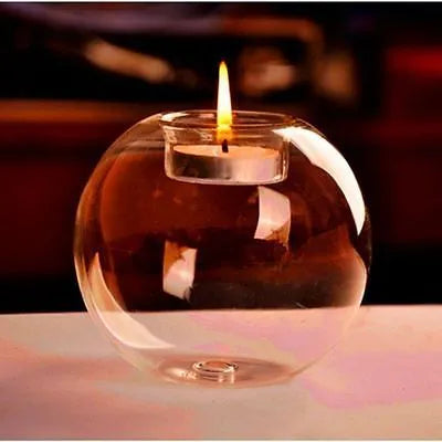 Handmade transparent round hollow glass candle holder for a tealight on a wooden table