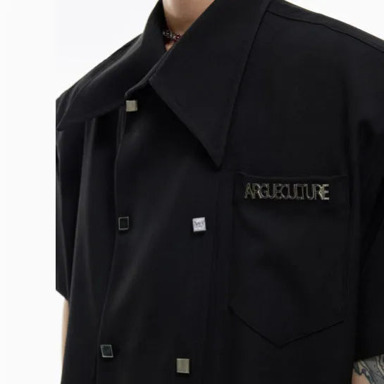 Man's loose-fit casual short-sleeve shirt with lapel collar in blue, showing splicing and button decoration details.