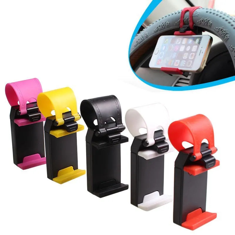 Black steering wheel phone mount holder clipped to a car wheel, holding a large smartphone.