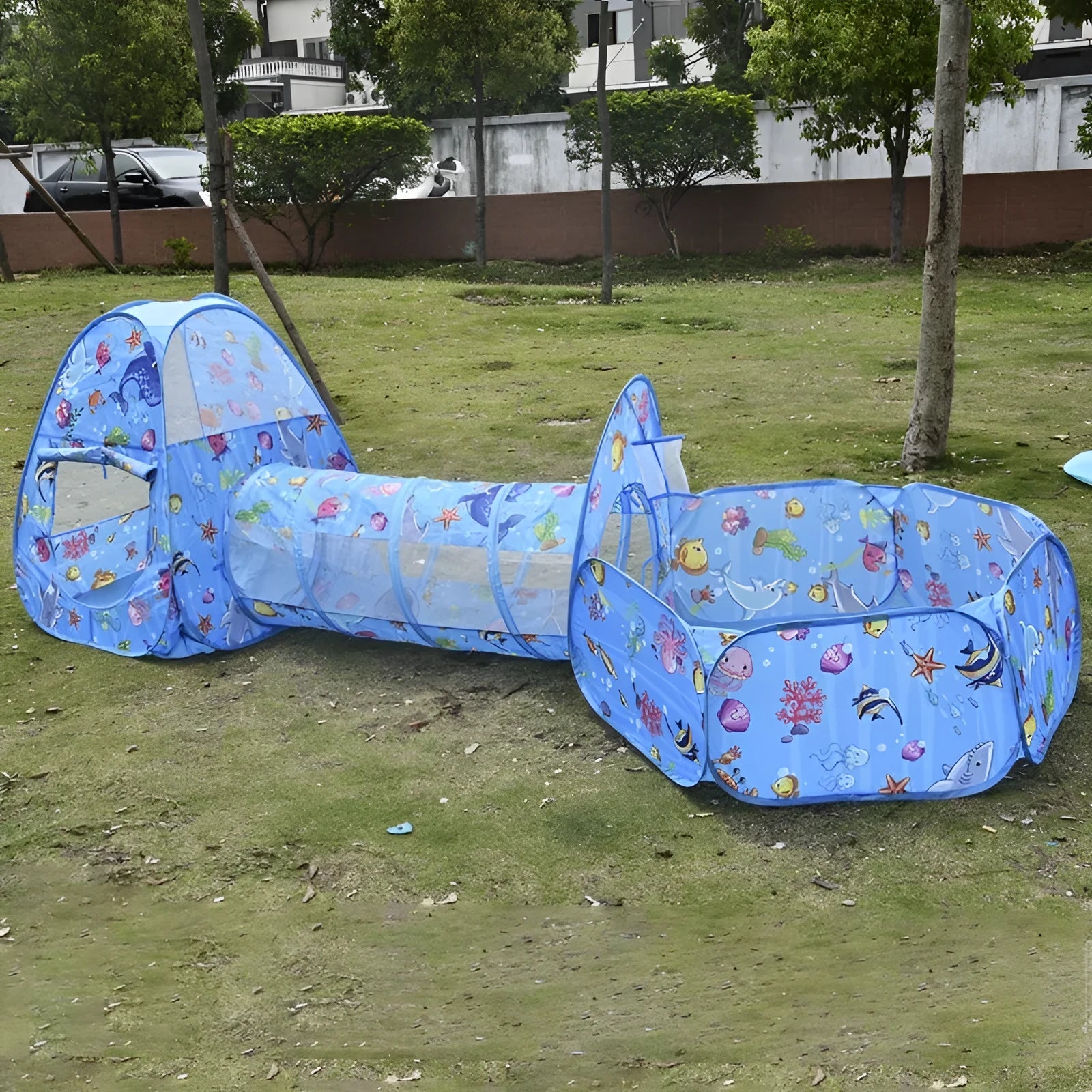 Colourful marine cartoon children's cloth tent with integrated ball pool and play tunnel.