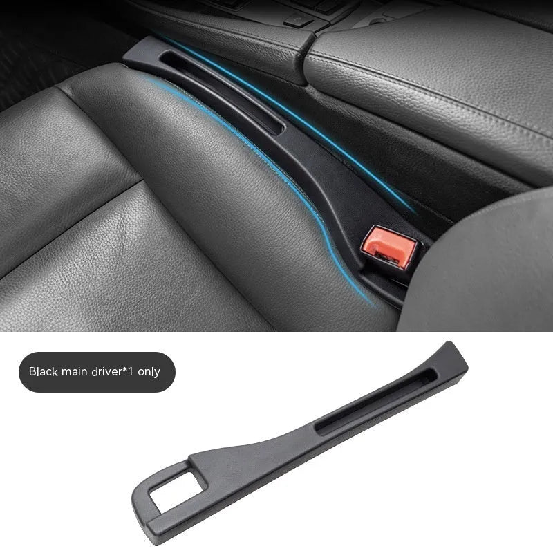 Black plastic car seat gap storage organiser box with a handle, shown inserted between vehicle seats.