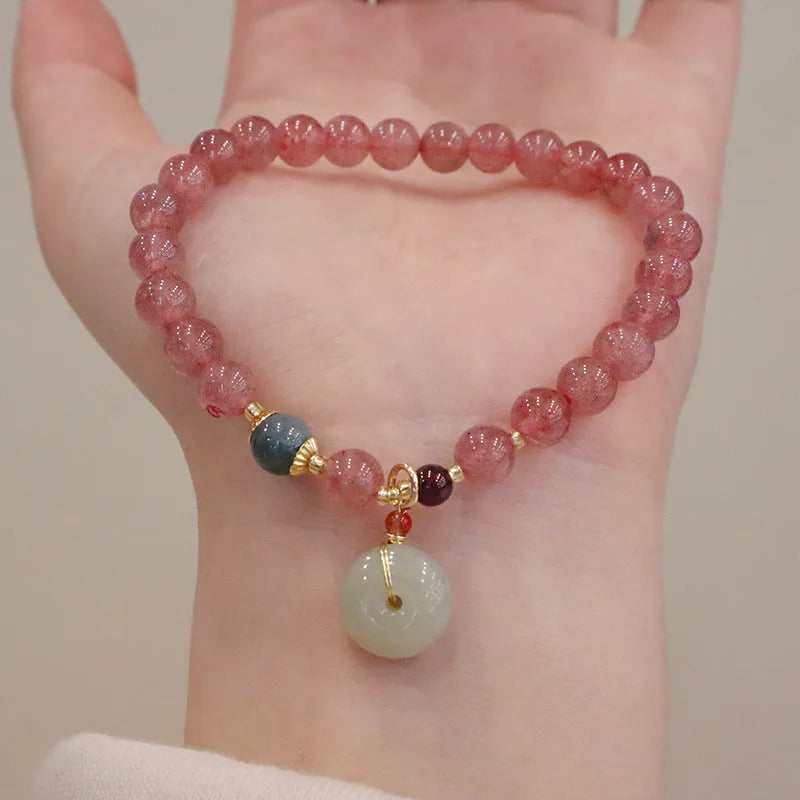 Natural strawberry quartz women's bracelet with purse charm detailing and peace buckle clasp