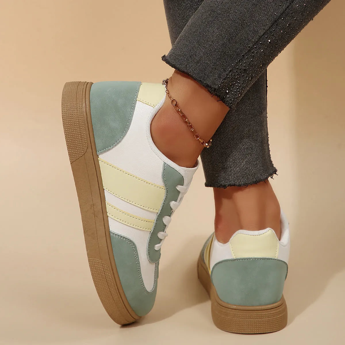 Green retro women's low-top pumps with cross straps, round toe, and flat rubber sole on a white background.